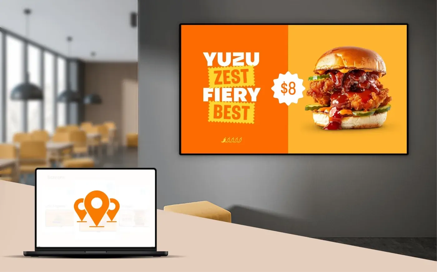 Restaurant wall screen showing a burger menu promotion, managed from a laptop dashboard