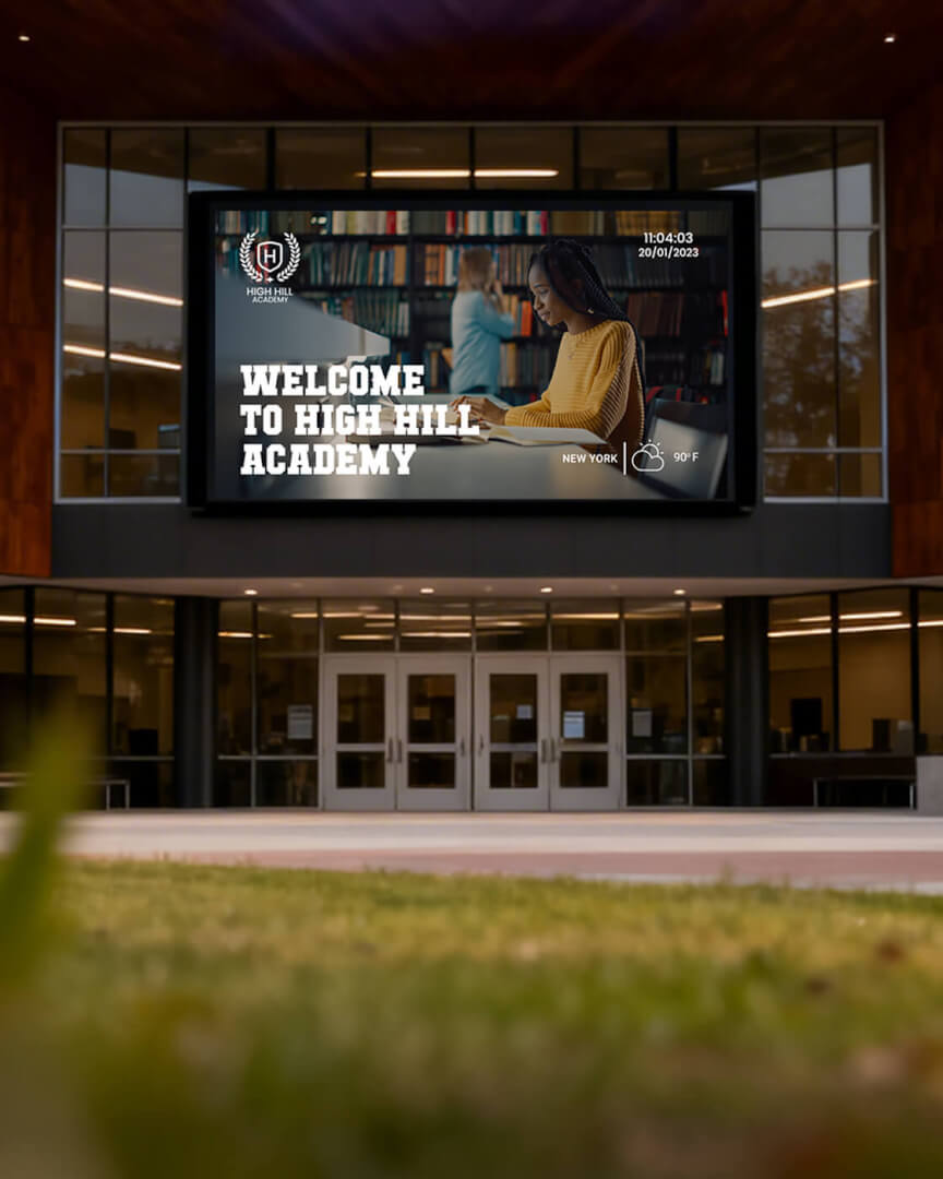 School entrance screen reading "Welcome to High Hill Academy" at dusk