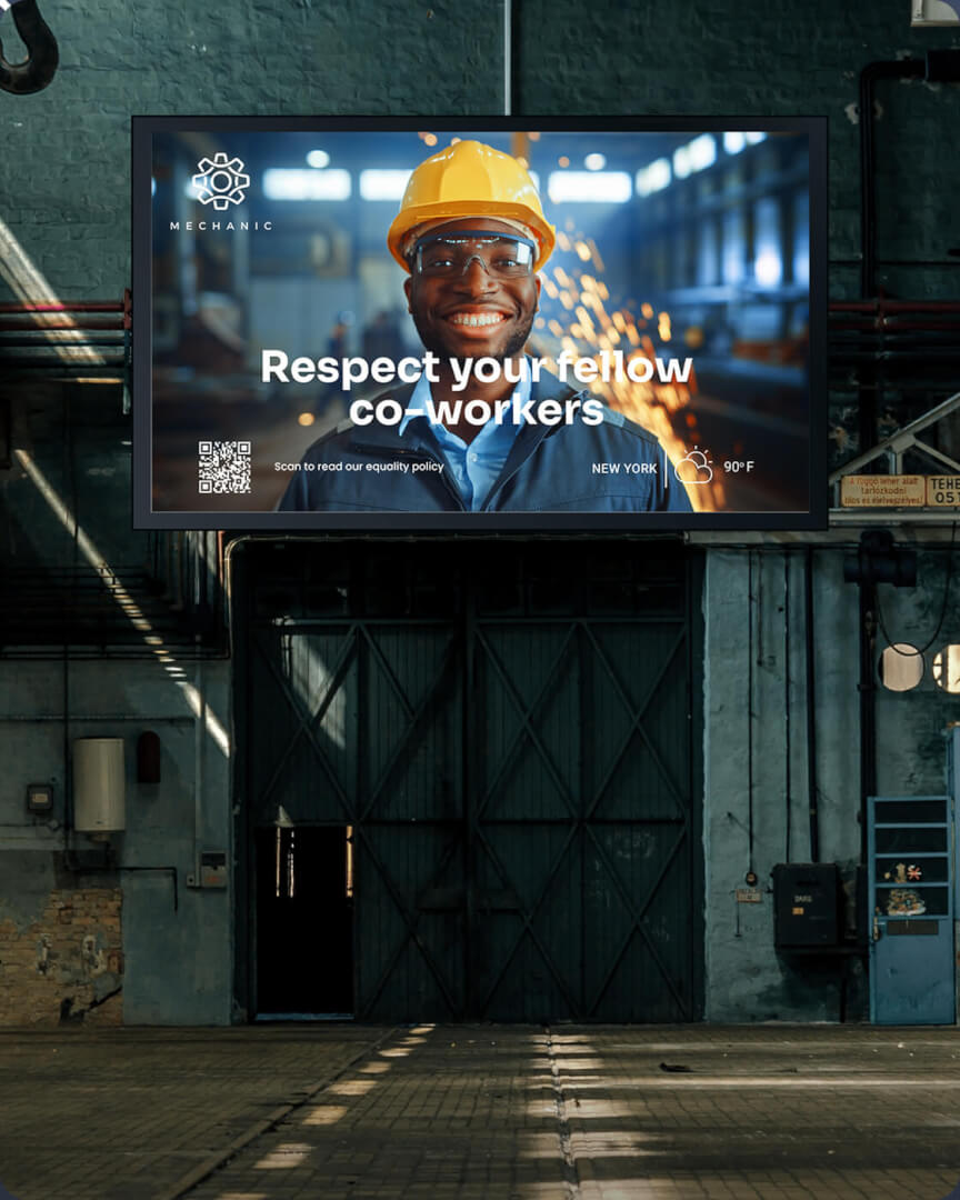 Industrial workshop screen showing a worker in a hard hat with the message "Respect your fellow co-workers"